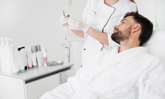 Oral surgeon examining a patient for signs of oral cancer