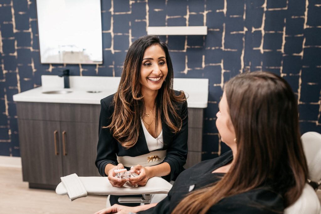 Oral surgeon consulting with a patient at Harmony Dental Implants and Oral Surgery in Charlotte, NC