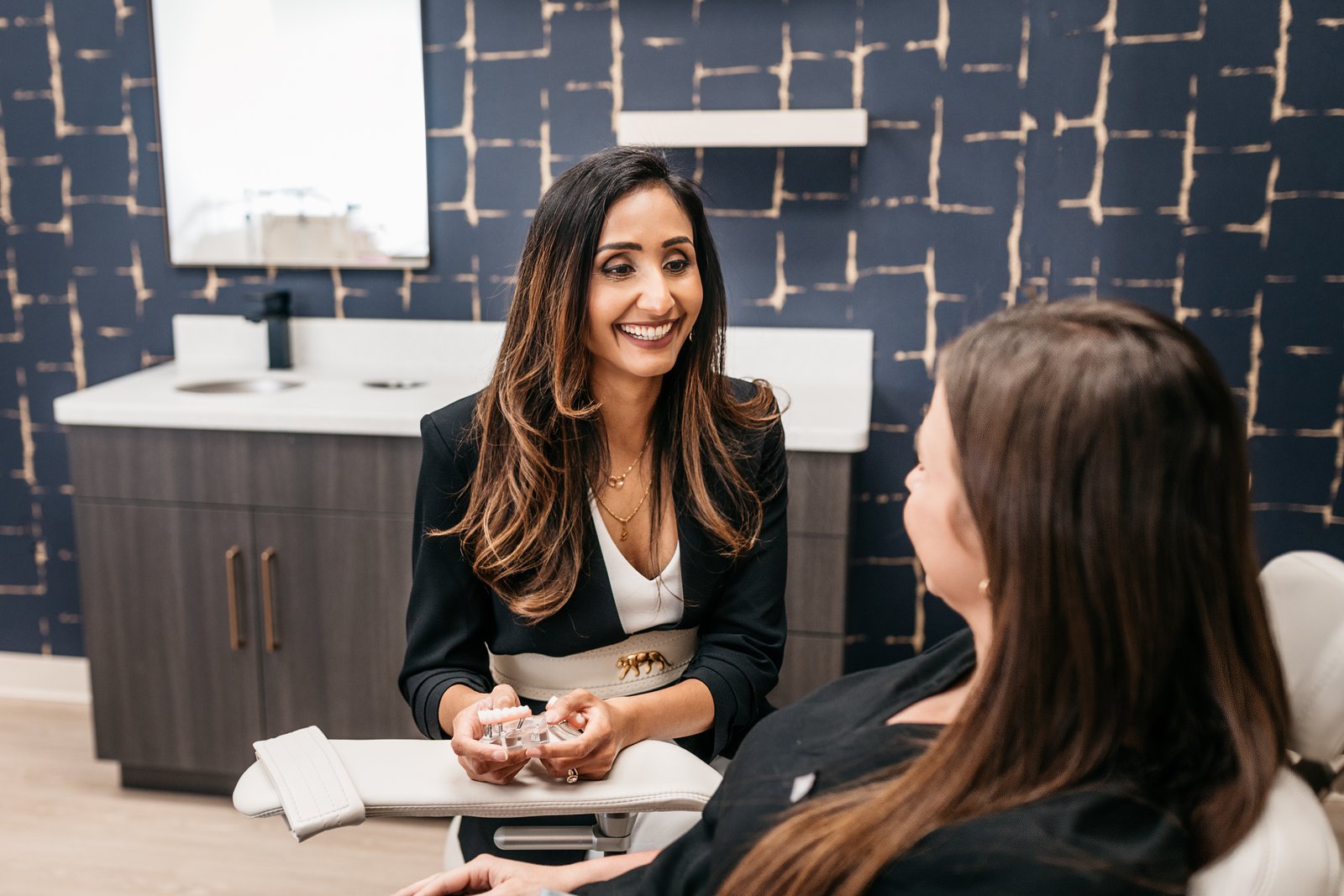 Oral surgeon consulting with a patient at Harmony Dental Implants and Oral Surgery in Charlotte, NC